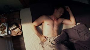 Sexy actor Patrick J. Adams wakes up in bed
